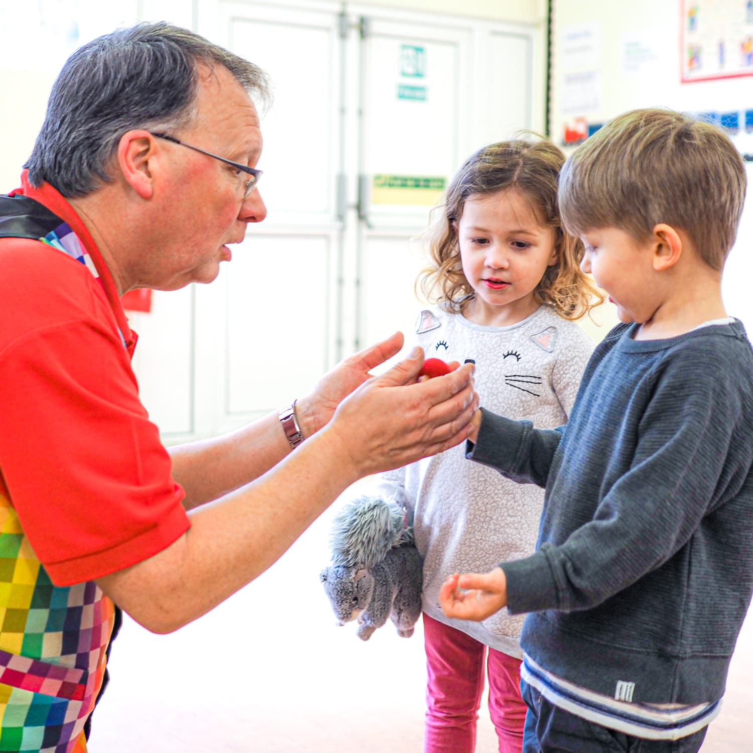 Two small children watching close-up magic