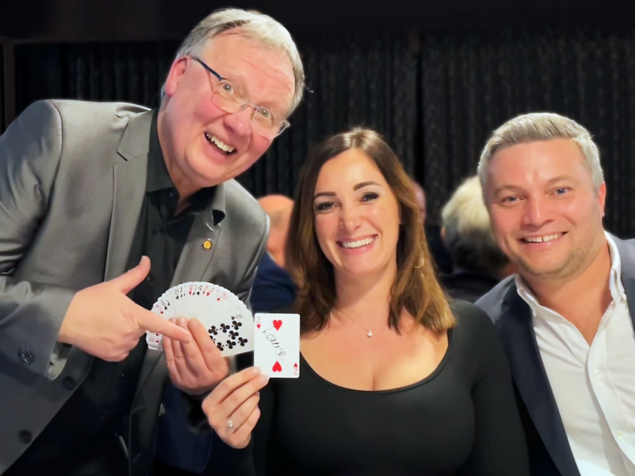A magician showing children close-up magic