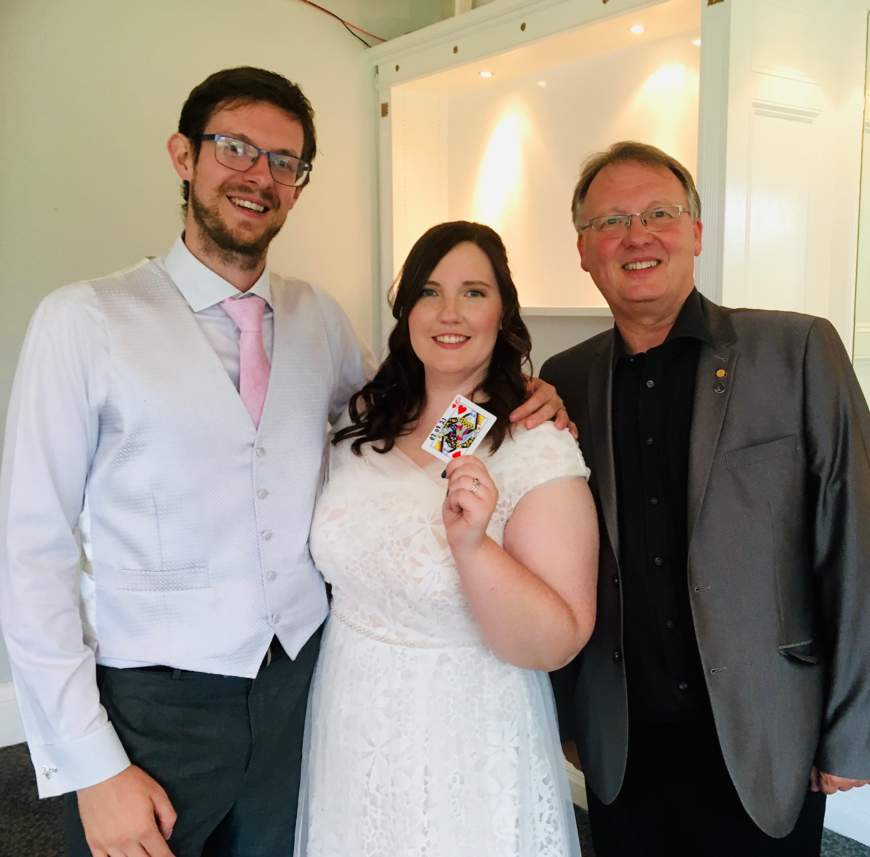 A bride and groom watching a magic trick