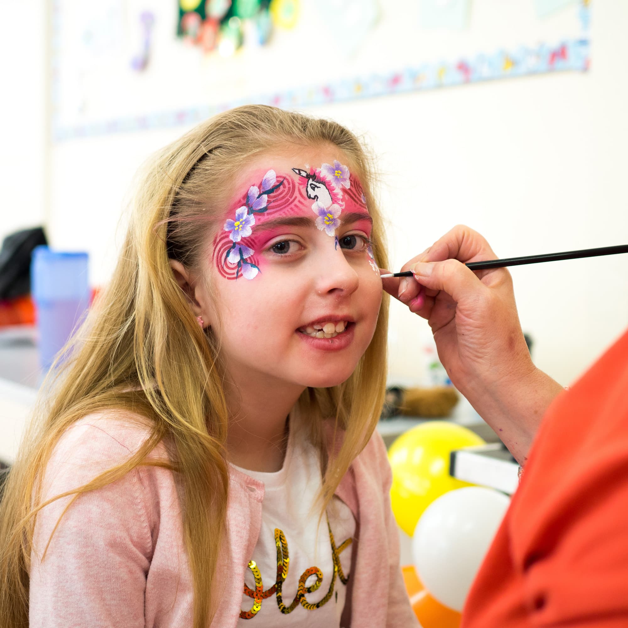 A child having their face painted