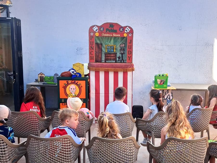 Children sitting patiently for the next Punch and Judy show